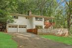 A private woodland oasis on the reservoir, just minutes to lovely downtown Croton Falls. Offering unparalleled connection to nature&rsquo;s beauty, this hillside retreat has amazing seasonal views of the Croton Falls Reservoir. Enter through the tree lined driveway and stop in the large parking area or two-car garage. Inside, find the bright and open living room, with wood-burning fireplace, hardwood floors and walls of windows that look out to the verdant natural surroundings. The living room (with a cool, modern light fixture) flows into the dining room, which is open to the kitchen - with stainless steel appliances and great counter space. Two good sized bedrooms and an updated bathroom that features a spa-like tile and glass shower complete this level. Below, you will find the large family room/den, with second fireplace and sliding doors out. Off of this is the private third bedroom, with another updated full bathroom. Back outside, the two level deck is perfect for entertaining, or just sitting to watch the beautiful surroundings. Hawks soar overhead, a deer ambles past, and squirrels hop along the stone walls. All of this, just seven minutes from Croton Falls, with its shopping, restaurants and train station. If you have been waiting for an affordable home in a beautiful setting, wait no longer.