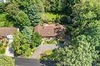 Welcome to serene living among the Cotswold neighborhood of the highly rated Edgemont School District, and the High School offers advanced placement programs. Conveniently located within walking distance to the schools, Metro North Train, and shops. The Contemporary home, alludes a tranquil vibe, nestled among the woods and nature. Set on half an acre (20, 038) sq. ft. property, and 6088 sq ft of livable space. The home offers a Gas Generator, new roof, gutters, three sky lights, hot water heater, and updated boiler 2024. Among, the upgrades, 2025 a new garage motor, with keypad, new bathroom ground level. Four bedrooms, four full bathrooms, opulent flex spaces, closets, laundry room and storage. The spacious Eat In kitchen flows into the family room, while enjoying a stone wood-burning fireplace. The formal dining room flows into both the Eat In kitchen and living room, relax while sitting in front of a Marble wood-burning fireplace. The mature landscaping was developed by one owner since 1983. The Property includes a 2025 land survey staking. One of the many perks are the yearly organized meet and greets, block parties, halloween, and holiday get togethers all organized by the Cotswold neighbors and enjoyed at the local park on Kempster.