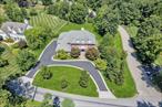 Welcome to FOX DEN ESTATES, an exclusive subdivision of custom-built homes located in the town of Yorktown, offering Yorktown schools and outstanding recreational opportunities. Pride of ownership is immediately evident at this stunning Center Hall Colonial, situated on a flat, beautifully landscaped .94-acre prime corner lot. The home features a circular driveway accented with Belgium block and a stately covered front entry with classic architectural columns, creating a grand first impression. Spanning over 6000 sq. ft. this home offers 5 bedrooms, 4.5 baths, 2 home offices, a full finished walk-out basement, walk-up attic, and two-car garage. The main level showcases a spacious foyer and two interior staircases on either side of the home, offering an elegant and functional flow throughout. The formal living room features a gas fireplace and decorative crown molding, while French doors open to an exquisite home office w. a wall of windows and custom floor-to-ceiling cherry wood built-in cabinetry. The formal dining room, complete with detailed crown molding and wainscoting flows seamlessly into the butler&rsquo;s pantry, creating effortless hosting. At the heart of the home, a stunning gourmet kitchen showcases an abundance of custom cherry wood cabinetry, including a thoughtfully integrated built-in desk w. a two-drawer beverage fridge, a majestic center island, granite countertops, tile backsplash, 5-burner gas range and double wall ovens. The sunlit breakfast area with a bay window overlooks the backyard and patio. The adjoining family room includes custom built-in cabinetry, decorative arched window moldings, a window seat, second fireplace (wood-burning), and French doors that lead to a patio - perfect for indoor-outdoor living. A well-appointed mudroom w. built-in cubbies, a private laundry room and a sophisticated powder room complete the main level of the home. Upstairs, the luxurious primary suite boasts a vaulted ceiling, two walk-in closets, and a third custom-designed walk-in closet and dedicated dressing room w. integrated shelving and built-in storage, combining elegance with exceptional functionality. The spa-like ensuite bath includes a seamless glass shower, oversized double sink vanity, Jacuzzi tub, and private toilet area. An adjacent bonus room, ideal as a private office or den features French doors that open to a charming front-facing balcony. Four additional generously sized bedrooms provide comfort and flexibility for family or guests. Two of the bedrooms share a Jack-and-Jill bathroom, while the remaining rooms are served by a stylish hall bath complete w. a tub/shower combination. Additionally, a hallway door leads to a spacious walk-up attic, offering exceptional storage and flexibility. The expansive, fully finished walk-out lower level is flooded w. natural light and offers valuable and versatile space for recreation, fitness, or multigenerational living. Complete with a full bath, dedicated exercise room, generous open-concept areas, abundance of storage, and direct access to the outdoors, itâ€™s a space designed to accommodate effortless entertainment and everyday enjoyment! Outside, a spacious yard is complemented by an impressive brick and stone patio, perfect for embracing the very best of outdoor living. The oversized driveway and attached two-car garage offers ample parking and convenience. Notable features and upgrades include hardwood floors, elegant crown moldings and trim, custom closets, recessed lighting, central AC, central vacuum, irrigation system, central alarm system, ring doorbell and interior/exterior audio. With its thoughtful design, quality finishes, and generous living spaces, this home is ideal for both entertaining and everyday living. Conveniently located just minutes from the Taconic State Parkway, transit, parks, schools, restaurants, and shopping. Move right in and enjoy all this home has to offer! Don&rsquo;t miss this opportunity to make this exceptional property your own!