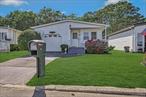 This home has all the extras. One of the largest models in the 55+ complex with attached one car garage. New roof in 2020. New deck in back yard 2024. Remodeled primary bath in 2021 with walk in shower. Remodeled primary bedroom in 2021 with laminate floors, high-end decorative molding and two closets with mirrored doors. Painted in neutral colors in 2020. Hall bath has a 5&rsquo; tub and easy access to a full size washer and dryer in closet with mirrored doors. Open floor plan from the Eat In Kitchen to living room. Formal dining room area with a pass through window to the kitchen has counter seating area. Lovely bay window in front of living room looks out to covered front porch. Kitchen has a sliding glass door to a comfortably enclosed three-season room. The relaxing three season room looks out on a view of 10 acres of serene forestland. Peaceful area perfectly located on the back side of development. Partially fenced with a shed in back yard. 19.5&rsquo; x 13.5&rsquo; garage has plenty of storage and interior access. Low taxes. Safely gated, active, adult community with Club house, billiards, in ground pool, gym, tennis/pickleball court, shuffleboard, bocce, BBQ, covered picnic area, pond, 7 day a week bus service to shopping and local towns. Ongoing activities from aerobics and line dancing to poker and sports clubs. Association fees cover Common Area Maintenance, Grounds Care, Pool Maintenance, Sewer, Snow Removal, Trash, Water. Must see!