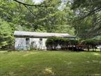 Great opportunity for a weekend getaway in the country! Plenty of room for all with main house and separate guest cottage all on nearly 2 acres of level private land. Close to conveniences, Eldred Schools, Port Jervis train station, Barryville Farmers Market, state lands, hiking trails, the Delaware river for recreation and so much more!. Main house has sliding doors to an outside deck for enjoying the country air, large eat in kitchen, bathroom, enclosed porch, spacious living room and one bedroom. The guest house has a kitchen, bathroom and bedroom nook in the living room. Great spot in Glen Spey NY only 2 hours NYC.