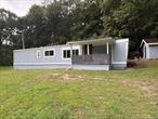 Privately set Three Bedroom , One bath, manufactured home with large 12&rsquo; x 30&rsquo; addition on almost an acre. Large rear deck looking out to private back yard for peaceful relaxation. Good sized Covered Front Porch. Nice size front, back and side yards for outside entertainment. New Double Pain Windows throughout, new laminate flooring, new kitchen cabinets, new moldings and freshly painted. This home is move in ready.