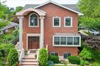Stunning 2012 Custom Brick Duplex â€“ Modern Luxury Meets Flexibility & Value! This exceptional five-bedroom, five-bath Contemporary duplex in Bayside offers the perfect blend of modern Italian craftsmanship, generous living space, and unmatched location. Built in 2012 on a spacious 5, 000-square-foot lot, the homeâ€™s stately brick fa&#231;ade, chimney, gated decorative driveway, and professionally landscaped grounds immediately set a tone of elegance and privacy. A fenced perimeter with a brick base and an iron railing adds both durability and visual appeal. Inside, soaring ceilings and oversized windows fill the open-concept living and dining areas with abundant natural light, highlighting the beautiful crown molding, recessed lighting, and glass-covered fireplace. The chefâ€™s kitchen is a true centerpiece, featuring custom Italian cabinetry, a Sub-Zero refrigerator, a Thermador professional-grade stove, dishwasher, and dryer, along with a decorative backsplash and Italy-glazed ceramic tile floors. A desirable first-floor bedroom and full bath offer flexibility for guests or multi-generational living, while heated floors in both the master and first-floor baths add everyday luxury. The master suite is designed for indulgence, featuring a chic double vanity, a garden tub, a separate stall shower, and custom Italian cabinetry, all framed by Hunter Douglas window treatments and enhanced by elegant chandeliers. The fully finished, high-ceiling basement is tailored for entertainment and functionality, complete with a dedicated home theater setup, an extra-large LG washer and dryer, and ample space for recreation. Throughout the home, comfort is ensured with Fujitsu split air conditioning units, central air, a smart thermostat, and a hot water heating system. For peace of mind, the property includes a comprehensive security system with outdoor cameras. Outdoor living is equally impressive, with a charming fish pond, a patio and terrace perfect for dining or relaxation, and a remote-controlled awning for effortless shade. Manicured lawns are maintained by a Pacific Lawn Sprinkler system, while the 500-square-foot garage and decorative driveway provide convenient and secure parking. Located within the coveted District 26 school zone, this home is just minutes from the Bayside LIRR station for a quick commute to Manhattan, as well as the vibrant dining and nightlife of Bell Boulevard and multiple green spaces, including Alley Pond Park and Golf Center, Oakland Lake, and Cunningham Park, to name a few. Offering a rare combination of upscale amenities, a flexible floor plan, and a prime Bayside location, this turnkey duplex is perfect for luxurious owner-occupied living, multi-generational households, or savvy investors seeking long-term value.
