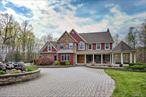 Tucked away on 12.3 acres in the iconic rolling hills of Warwick, 14 Stonewall Court is more than a houseâ€”it&rsquo;s a lifestyle. Pull through the wrought-iron gate and be welcomed by a beautiful paver driveway, a triple-waterfall fountain, and four-seasons sunset views over a peaceful, private lake. This custom Arts & Crafts Colonial, built in 2005, has been meticulously updated over the last four years, blending impeccable craftsmanship with modern luxuries. The gourmet kitchen is a chef&rsquo;s dream, featuring high-end appliances, a large island, stone countertops, and custom cabinetry. It flows directly into the open living room, complete with a cozy wood-burning fireplace. A large dining room with a butler&rsquo;s hallway, a formal living room, and a laundry room complete the first floor. Throughout the home, you&rsquo;ll find luxurious details like oversized hallways, 10-foot ceilings, custom columns, and intricate moldings.Upstairs, the multi-room primary suite is your personal sanctuaryâ€”large and bright with oversized windows overlooking the lake, vaulted ceilings, a gas fireplace, and custom built-in closets. The ensuite bathroom features a walk-in steam shower and a Bain Ultra Jacuzzi. Three other spacious bedrooms are on the other side of the upper level, all with custom closet systems. Two bedrooms share one bathroom, and the third is an ensuite, with all second-floor bathrooms boasting tiled steam showers. The lower level is a large, open finished space with walk-out access to the backyard and a full bathroom. It also includes a dedicated movie theater room with platform seating and remote lighting for the ultimate entertainment experience.Step outside and you&rsquo;ll enter a captivating backyard oasis. You&rsquo;ll find a brand new 2024 saltwater pool with LED Lighting and a peaceful 2.5-acre, stream-fed lake that&rsquo;s home to fish and a resident bald eagle. The lake has a dock with electric at the shoreline, perfect for relaxing. Beyond the lake, the acreage continues with elevated wooded land, ideal for hiking, biking, snowshoeing, and more. This home is truly a four-season entertainer&rsquo;s dream, with an open floor plan and a fabulous backyard. Other notable features include cherry flooring refinished in 2021, New Water Softener 2025, a Hunter Irrigation System, a new dock and lake aerator installed in 2021, a Crestron lighting system, a full-house generator (ready to be hooked up), and an Autel Level 2 EV charger. The location is unbeatable: top-rated Warwick schools, just minutes from the Villages of Warwick and Florida, walking distance to the Warwick Valley Winery, and only 60 miles from NYC.