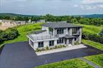 Experience Unmatched Luxury and Space. Be the first to call this newly constructed estate your own: an exquisite residence on 1.31 private acres, offering over 5, 600 sq. ft. of light-filled, meticulously crafted living space. Designed with attention to detail, it features 10-foot ceilings, oversized rooms, and designer finishes throughout. Enjoy two luxurious primary suites with spa-style en-suites and walk-in closets. Two additional bedrooms open to private decks, offering flexibility and comfort. The layout includes a full bath, three powder rooms, a formal dining room, and a stunning great room with fireplace: perfect for entertaining. Upstairs, a spacious family lounge opens to a serene terrace, ideal for quiet moments. The gourmet kitchen impresses with custom tall cabinetry, a large island, high-end appliances, and a sun-filled breakfast nook. The finished lower level is ready to entertain with radiant heat floors and a built-in bar. Additional highlights include a 2-car garage, central HVAC, and refined craftsmanship throughout. Located just 2 miles from Beltzville Lake: offering motor boating, hiking, and a sandy beach: this is a rare opportunity to own a sophisticated retreat where luxury and lifestyle meet, also 20 Mins. From Blue Mountain Ski Resort. Taxes are currently on land only; property will be reassessed.