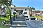 Welcome to this stunning, completely remodeled, custom-designed modern colonial in Holliswood, finished to high-end specifications in 2022. Offering approximately 3, 000 sq. ft. of luxurious living space on a 7, 667 sq. ft. lot, this home features 3 spacious bedrooms, 2 full bathrooms, and 2 half bathrooms, complemented by state-of-the-art smart home automation. A wide, statement floating staircase leads to expansive formal living areas, while the European custom kitchen boasts Bosch appliances, premium countertops, a large stone waterfall island with seating, and a dining area. Radiant heated floors with separate zone controls, ductless AC on the main level, motorized window shades, Marvin windows, touchless smart dual sinks, and an integrated Sono sound system provide comfort and modern convenience. The primary suite includes a boutique-style European custom walk-in closet and spa-inspired dual bathroom, with additional bedrooms featuring custom walk-in closets and a shared dual vanity bath. The finished lower level offers a half bathroom, laundry area, and direct access to the garage, while the exterior features a fully paved backyard with a pergola-covered area and basketball playground, custom landscaping, and an attached heated-floor garage with a Tesla charger and a private driveway accommodating up to four vehicles. Located near major transportation, highways, shopping, and schools, this move-in-ready home perfectly combines luxury, convenience, and modern living.