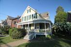 Multiple offers situation. Highest, final, and best offers are due by 5:00pm Thursday 8/28/2025. Step back in time with this beautifully preserved 1890 Victorian Colonial, lovingly held by the same family since 1901. Nestled in the heart of the Village of Wappingers, directly across from picturesque Mesier Park, this unique home offers character, charm, and an unbeatable location. Inside, you&rsquo;ll find gleaming hardwood floors, a pink mahogany banister, and a covered wraparound porch adorned with carved woodwork, perfect for enjoying morning coffee or evening sunsets. The eat-in kitchen offers ample space for meals and gatherings, with one bedroom and full bath conveniently located on the main floor. Upstairs, discover three additional bedrooms, another full bath, and a fully equipped second kitchen, providing flexibility for multi-generational living. The cellar features a traditional dirt floor, offering rustic storage space, while a detached two-car garage provides off-street parking. The spacious backyard stretches well beyond the garage, framed by mature landscaping, including decades-old hydrangea trees that bloom beautifully each season. Located just steps from the park, stroll through Mesier Parkâ€™s walking paths to enjoy local restaurants, cafes, shops, and the public library â€” all just a short walk away. The neighborhood boasts lovely sidewalks and a true village feel. This property is being sold as-is Cash or conventional financing only. A rare opportunity to own a piece of local history in an ideal location in the Hudson Valley.