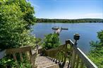 Experience the magic of waterfront living with expansive, unobstructed views of Northport Harbor and the Long Island Sound. This rare four-bedroom, 3.5-bath home is perfectly sited on .62 acres of private, beautifully landscaped property with 221 feet of direct waterfront and your very own dockâ€”ideal for boating, fishing, paddleboarding, or kayaking right from your backyard.Inside, floor-to-ceiling windows flood the home with natural light and frame breathtaking views from nearly every room. The updated granite eat-in kitchen flows into a spacious living room with a wood-burning fireplace, perfect for cozy evenings by the water. The first-floor primary suite offers a private deck overlooking the harbor, a serene retreat to start and end your day. A sunroom with another deck invites you to relax and soak in the scenery year-round.Upstairs, youâ€™ll find three additional bedrooms, all boasting water views, and a full bath. The walk-out lower level is designed for entertaining, featuring a large recreation room with fireplace, a summer kitchen, full bath, laundry, and utility roomâ€”all with captivating harbor vistas.This is more than a homeâ€”itâ€™s a lifestyle. Donâ€™t miss the opportunity to own your personal slice of waterfront heaven in Harborfields School District*Some Interior Photos Have Been Virtually Staged*