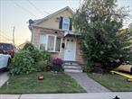 Great 4 bedroom, 2 bathroom house with hardwood floors throughout. Unfinished basement, 2 car detached garage. Driveway for 3 cars.  House is half block from busses, close to highway, school, and shopping.  Only 1 mile from Hofstra University.