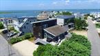 Nestled in one of the most sought-after communities on Dune Road, this beloved beach home exudes classic seaside charm. Designed in a timeless coastal cottage aesthetic, it features hardwood flooring, elegant wainscoting, and soaring vaulted ceilings. The bright and airy living room opens to glass doors that showcase serene bay views and lead to a private deck complete with a hot tubâ€”perfect for unwinding. Offering three generously sized bedrooms with picturesque vistas and two beautifully updated full bathrooms, this home is just a short stroll to the bay. A perfect blend of comfort, style, and location.