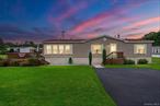 Step into this beautifully designed manufactured home that combines comfort, style, and convenience. Street facing so the small community behind the park goes unnoticed. So close to downtown amenities, and many other perks. Bright and spacious with wide, high ceilings and skylights, this home is filled with natural light, creating an inviting and airy atmosphere. The open layout features an Eat-in kitchen with plenty of counter space, a bar countertop perfect for casual dining or entertaining, and a formal dining area for special gatherings. Offered fully furnished, every detail has been thoughtfully designed to provide a turnkey living experience. This is a rare opportunity to own a move-in ready home that blends modern charm with everyday functionality. The large deck is a nice place to take in the sun and relax or entertain. Very quiet and comfortable with full new driveway, lush green front yard beautifully maintained. Gorgeous Mountain views- country living but not too far from city life. This move-in ready home comes with Washer and dryer in the small laundry room off the kitchen and is in excellent condition.