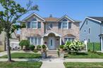 This Beautiful Colonial Has Timeless Sophistication In Rockwood Park Section Of Howard Beach. This Brick Front Home Blends Traditional Charm With Modern Comforts. Boasting Spacious Living Areas, Rich Hardwood Floors, Crown Molding, And Oversized Windows And Skylights That Fills This Home In Natural Light, No Detail Was Overlooked, Kitchen Is Appointed With Stainless Steel Appliances, Quartz Countertops, With A Breakfast Bar. Large Sun Drenched Living Room Featuring A Fireplace, Vaulted Ceilings With Sliding Doors Leading To Your Backyard. Upstairs, Has Generously Sized Bedrooms, While The Spacious Primary Bedroom Features A Walk In Closet And Cathedral Ceilings, Two Additional Bedrooms, And An Updated Full Bath With A Soaking Tub And Separate Shower. Outside, The Manicured Grounds Include A Private Backyard Retreat Ideal For Relaxing Or Hosting Your Next Gathering! Long Driveway That Accommodates 3+ Cars On A 50X100 Lot. Located On A Picturesque Block Close To Schools, Parks, Shopping, And Transportation. This Home Offers Both Convenience And Prestige In One Of Queensâ€™ Most Desirable Communities.