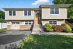 Beautiful Bi-Level in Sloatsburg, NY. Built in 2009, this residence feels nearly like new construction. A striking vinyl and stone facade, paired with a generous driveway, creates an impressive first impression.Inside, gleaming hardwood floors and a freshly painted neutral palette extend throughout both levels. The formal living room features a large picture window, gas fireplace, and custom built-ins, while the adjacent dining room flows effortlessly into the kitchen and offers access to a deckâ€”perfect for grilling or dining al fresco.The kitchen is a true centerpiece, showcasing rich cherry cabinetry, granite countertops, and stainless-steel appliances. Designed with the cook in mind, it offers abundant workspace and storage.Down the hall are three bedrooms, all with new carpeting. The primary suite includes a double-door closet with custom system and an ensuite bath, while the additional bedrooms share a well-appointed hall bath.The lower level expands your living options with a spacious family room that spans the depth of the home, easily accommodating both work and play. A fourth bedroom, powder room, and large laundry/utility room enhance the functionality, along with access to an oversized one-car garage.Set in a serene neighborhood, this home offers the best of Sloatsburg living. Just minutes from Harriman State Park, outdoor enthusiasts will love the hiking, biking, and scenic lakes. NYC commuters will appreciate the convenience of the nearby train station and bus options. All this, within the sought-after Suffern Central School District.