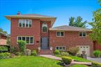 Rarely Available in Jericho Schools! This extended brick home is truly better than new, blending timeless charm with modern comfort. The main level offers a seamless flow from the inviting living room and formal dining area to the enormous chefâ€™s kitchenâ€”a true showstopper with direct access to the serene backyard. Upstairs features three generously sized bedrooms, including a spacious en-suite with a walk-in closet, while the top-floor primary suite is a private retreat with soaring cathedral ceilings and a brand-new sizable bath. A playroom adjacent to the family room adds flexibility as a potential fifth bedroom, perfect for guests or multigenerational living. The huge backyardâ€”a rare find in this areaâ€”pairs perfectly with a young roof with solar panels, 2 Car Garage, gas cooking, and gas heating and much more. Perfectly situated just steps from Seaman Elementary, the library, and Whole Foods mall, this stunning home with custom finishes offers unmatched sophistication, convenience, and comfort. A must-see that wonâ€™t last!