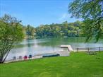 A dazzling opportunity to own an epic property in Armonkâ€™s coveted Windmill Farm community, privately set behind its own gate on 1.2 acres. This rare North Lake waterfront home offers just under 5, 300 sq ft of living space and over 220 feet of shoreline on 135-acre North Lake, with a private dock for swimming, boating, and fishing, plus spectacular views from almost every room. A lovely, gently sloping lawn stretches from the house to the waterâ€™s edge, creating a serene, park-like setting.Thoughtfully custom-built with quality finishes, the home features a charming rocking chair front porch, sun-filled open spaces, and a comfortable flow ideal for both lively entertaining and everyday family living. Two stone patios overlook the lakeâ€”perfect for summer gatheringsâ€”while a beautiful balcony off the primary bedroom is an inviting spot to enjoy your morning coffee or a good book. A sandy beachfront invites you to build sandcastles, sink your toes in the warm sand, and savor the simple joys of lakefront living. From summer kayaking to winter ice-skating, every season offers a new way to enjoy this one-of-a-kind settingâ€”just minutes to Byram Hills schools, downtown Armonk, and Metro-North, and only an hour from NYC.