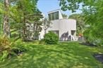 On the market for the very first time, The Porter House, designed and built by world renowned architect Myron Goldfinger for the award winning fashion designer Regina Porter. The home sits on a 1.4 acre lot on a quiet street in Quogue backing up to preserved land leading to Philips Creek. The property grounds thoughtfully created by a well know landscape designer of Asian influence. Identified by the poolside Elsie Pinsker sculpture and antique Hong Kong rickshaw. The home contains 4 bedrooms, 3 baths, swimming pool and tennis court. Despite its uniqueness, one of only three Goldfinger homes in the Hamptons and meticulous maintenance it is priced in conformance with the neighborhood. Visits by appointment only.