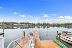 Stunning waterfront 2 family used as 1 family - perfect for those who appreciate water activities and daily sunset views. Building is 22x57 on a 27x120 lot, with 5 bedrooms and 3 bathrooms. Direct access to Atlantic ocean via private dock and boat slip with new pilings and new retainer wall. The home has an endless pool where you swim against pressure or walk in the inside the pool treadmill. Automatic cover covers the pool and the pool enclosure is retractable. Finish Sauna and Steam Room.  Custom chef&rsquo;s kitchen made from Canadian wood which can be repainted for any desired color. House has 3 tankless boilers, 3 heating systems (HVAC, spit units, and water radiant floor heating). Tesla/EV charger and fully paid for solar panels with battery for emergency back up. The attic also offers expansion potential for an additional floor. Enjoy the picturesque views of the waterfront, golf course, daily sunsets. Parking for 3 cars not using the garage. Nest cameras and thermostats for smart home access. The property is a rare blend of recreation, sustainability, and sophistication - ideal for luxury living and entertaining.