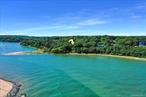 This breathtaking beachfront property in one of Port Jefferson&rsquo;s most prestigious locations is available for the first time in over 50 years! The home is nestled in the woods at the water&rsquo;s edge, with captivating views of Long island Sound and an entertaining parade of boats.What makes this property truly unique is the inclusion of a second buildable waterfront lot -a pairing that opens the door to opportunities and imagination. Whether you build a guest retreat, a second house, or hold it as an investment, property of this caliber is exceedingly rare.The classic 4000 s/f Colonial home was sturdily built in 1974, with 6 working fireplaces and water views from every room. Sprawling porches invite you to enjoy the refreshing sea breeze, and the sound of gentle waves lulls you to sleep at night. With 5 bedrooms and a full/partially finished walk-out basement, there is plenty of space for entertaining and expansion. Another unique feature of this property is the abundance of mature trees, which provide cooling shade and privacy in the summer, but drop their leaves in winter to reveal panoramic views of Mt. Sinai Harbor. Kaleidoscopic sunrises over the salt marsh illuminate the rooms with extraordinary pink light from the East in the morning, and then in the evening you can enjoy sunsets over Long Island Sound while grilling on your deck.Step through the garden to jump in the water for a swim! You can even keep a sailboat docked at the end of your beach path. Rarely does such an extraordinary parcel of land come to market. Everyone who sets foot on this land falls in love!Total 2.09 Acres - Taxes for the one-acre buildable lot: Brookhaven: $3, 085.31 PJ Village: $404.66Taxes for the 1.09Acre/4000 s/f Colonial: Brookhaven $19, 992.80 PJ Village: $3, 893.80