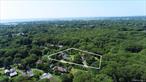 One acre of opportunity in Quogue. This rare offering provides the perfect canvas to create your dream estate, with room to build a Â±5, 000 sq. ft. residence complete with pool and pool house. The property currently includes a Â±1, 800 sq. ft. main home with three bedrooms and two and a half baths, a two-bedroom cottage, an additional outbuilding with electric, and an oversized detached two-car garage. With existing rental income in place, you can enjoy flexibility while planning your future build in one of the Hamptonsâ€™ most coveted locations.