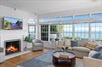 Discover your dream waterfront retreat in this spectacular Peconic Bay home, where luxury meets tranquility. This stunning property features an inviting open floor plan that seamlessly blends elegance with comfort. Soaring high ceilings create an airy atmosphere, while abundant natural light enhances the spacious interiors. The living area flows effortlessly to a charming deck, offering breathtaking views of the bay. A unique feature of this property is the charming carriage house, complete with an expansive loft. This versatile space can serve as a guest suite, home office, or creative studio, providing endless possibilities.With beautifully landscaped grounds leading directly to the water, enjoy boating, kayaking, or simply relaxing by the shore. Moor your boat right out front! Discover the breathtaking vineyards of the North Fork, unwind by serene shores, and visit local farms. Expansive primary ensuite with walk in closet on the first floor!