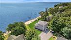 This stunning waterfront residence features over 100 feet of private beach and embodies the essence of coastal living. This three-bedroom, three-bath home built in 2024, boasts an open floor plan, highlighted by a wall of windows that captures breathtaking views of Peconic Bay, creating an inviting space perfect for entertaining. The chef&rsquo;s kitchen, equipped with custom cabinetry and elegant countertops, fosters culinary creativity and includes a spacious island for gathering with loved ones. Two of the bedrooms boast a private top-floor balcony, while the third bedroom is conveniently located on the first floor. The spa-inspired bathrooms are beautifully appointed with exquisite tile and fixtures. The finished lower level features a recreation room with a bar and lounge area, along with a versatile bonus room that can adapt to your needs, serving as an office, gym, or extra storage space. Step outside to the waterfront observation deck, a serene oasis for enjoying the captivating beauty of sunrises and sunsets over the bay. The lower-level storage area provides practical solutions for all your beach essentials, from paddleboards to kayaks. Nestled in a quaint hamlet, this residence offers easy access to the best of the North Fork, where shopping, vineyards, farm stands, and restaurants await your exploration.