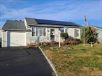 Lovely 3 bedroom Wide Line Cape on a 60x100 level lot. This property has winter water views and is facing the sound. Private driveway with enclosed, expanded, one car, heated garage. Private fenced in rear yard. Updated Kitchen, windows, hot water heater, roof, bathroom, siding. Rear Deck and Patio. Skylight in Bathroom. Put your personal stamp on this affordable water community home. Property has solar panels.