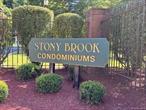 TOWN OF NEWBURGH - STONY BROOK CONDOMINIUM COMPLEX...Updated private top floor 2-bedroom, 2-bathroom brick end unit with 1282&rsquo; sq. ft. living space with 1-car garage with washer/dryer in the unit. Complex offers: clubhouse, inground pool for the hot days of summer, tennis courts, professionally landscaped grounds and private parking. This unit has gleaming hardwood floors through out and in impeccable condition. The private entrance has hardwood stairs with carpeted runner. The unit offers an open living room, dining room with door opening to a newly renovated deck overlooking the relaxing view of the greenery and sky. The kitchen has a bay window for extra sunlight and stainless steel appliances included with sale. Crown molding throughout the common areas, central air and 9&rsquo; high ceilings throughout. The primary bedroom suite has a bay window for extra sunlight, walk-in closet, updated bathroom with shower and dressing area. The second bedroom has an entire wall closet. The second bathroom with tub and ceramic tiled walls and flooring. Easily accessible and convenient stackable washer/dryer in the hallway closet. Garage (with opener and remote ) and utility room has room for some storage. This unit has energy efficient gas heating and cooling. The HOA covers water, sewer, trash removal, snow plowing and lawn maintenance.