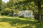 Experience this mid-1800&rsquo;s East Chatham home built from local stone with wood clapboard siding. Lovingly updated, by the architect owner, in the early 2000&rsquo;s, it is now poised for the next chapter of its storied history. Set back on a quiet country road, the home is nestled on almost eight acres and surrounded on all four sides by state protected and preserved lands. A combination of stone patios, wood deck and screened-in porch connect the home&rsquo;s interior to the surrounding gardens. From each of these outdoor rooms, one can experience the privacy afforded by mature landscaping that also frame long-distance pastoral views. A stone path leads to a stone landing at the home&rsquo;s entrance. Convenient to the entrance, and part of the home is a functioning garden shed. The two-story home with a walk-out lower level has a full bath on both the first and second floor. The partially finished basement could easily accommodate a third full bath. Central to the first floor is the kitchen, with dining area off to one side and a beautifully screened-in porch to the other. Direct access to a deck off the dining room offers yet another choice for morning coffee or entertaining. Cozy up to the wood burning fireplace in the living room with natural lighting streaming in on all three sides. The second floor has two bedrooms that share a full bath. Each room gives a sense of spaciousness with comfortable ceiling heights and again, filled with natural light, True country living, offering a sense of peace and tranquility from every corner of the property and home. All within a short drive to Chatham and the Berkshires and 30 minutes to Albany and Hudson.