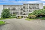 Welcome to High Point Condos of Hartsdale. This highly regarded 24/7 gated community provides secure, single-level living for its residents. Building 100 features an impressive, newly renovated welcome area and is conveniently located next to the elevator offering quiet, efficient access to the fourth floor. Unit #410, a spacious end unit, benefits from abundant natural light and an open-concept layout. The two-bedroom, two-bath residence includes a custom eat-in kitchen with walnut cabinetry, pantry, granite countertops, tile backsplash, modern lighting, built-in storage, large refrigerator, dishwasher, electric range with microwave, and wide plank hardwood flooring that seamlessly extends into the main living area.The dining space accommodates a table for six and offers custom china cabinets for additional storage, ideal for entertaining. Sliding glass doors open to a covered balcony with wooded views, suitable for outdoor seating or dining. The main living area is lined with expansive windows, providing flexibility for various furniture arrangements. The primary bedroom comfortably fits a king-size bed, nightstands, and multiple dressers. It also offers a custom walk-in closet and a dedicated vanity with sink, complemented by an updated bathroom with a shower/tub combination. The second bedroom is generously sized with a large closet and is conveniently situated across from a second full bathroom featuring a sliding glass door shower, updated vanity sink and ample counter space.Laundry facilities are available on each floor. Included with this unit are one deeded garage parking space (#309) and an 8x4 foot storage unit (#17). High Point Condos provide residents with an onsite superintendent, Olympic-sized pool, 24-hour fitness center, clubhouse complete with kitchen, lounge with flat screen tv, and a spacious dining area suitable for events. High Point offers a comprehensive range of amenities, making it a desirable and well rounded community to call home!