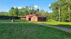 Beautiful ranch on a quiet country road, by Amber Lake which includes lake rights. This property offers lots of privacy and tons of space inside and outside. Walk right into the large dining room/living room with hardwood floors connecting you to a cozy kitchen with a back porch running through almost the entire house, it has five nice size bedrooms enough room for an extended family and guest, two full baths. Perfect for a vacation home but can be used for an all year round residence as well. Enjoy the country views whether you sit on the front porch or while relaxing on the oversized back porch, or just by steering out any of the many windows.