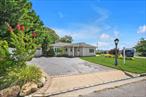 Welcome to this immaculate corner ranch home with water view, offering 3 generously sized bedrooms and 2 renovated bathrooms in a bright, open layout. The modern kitchen features stainless steel appliances and a brand-new refrigerator, complemented by gleaming wood floors throughout. The living room boasts a fireplace, cathedral ceilings, and a wall-to-wall window with stunning bay views. Outside, enjoy a private patio, detached garage, and a driveway with room for up to four additional cars.