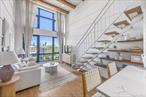 Exceptional 1BR/2BTH + Office Duplex Condo in Greenpoint!This sun-filled 1BR/2BTH condo is a thoughtfully reimagined duplex where modern luxury meets custom design in the heart of Greenpoint. This unit offers soaring 14-foot ceilings, curated finishes, and an effortless blend of style and functionality, all within a boutique 7-unit condominium.Step inside through a foyer accented with shiplap detailing and custom hooks, leading into a chefâ€™s kitchen outfitted with Miele and Bosch stainless steel appliances, quartz countertops, and soft-close cabinetry with a stone backsplash. Just off the entry, two oversized closets provide abundant storage.The spacious living room boasts new ceiling boards, custom built-in library shelving, and striking board-and-batten millwork across every wall. From here, step onto your private balcony with open skyline views, perfect for morning coffee or evening unwinding.The bedroom has been freshly painted in a sophisticated Forrest Green limewash, complemented by all-new millwork in the massive closet, blackout curtains, and a woven statement light fixture. The main bathroom offers spa-like tranquility with a deep soaking tub, bidet toilet seat with remote, and integrated Bluetooth speaker lighting.Upstairs, discover a versatile office/guest room with designer touches: full board-and-batten walls, wallpapered ceiling, and a shiplap accent wall. The second bathroom features a rainfall shower with body jets and Bluetooth speaker lighting. A dedicated laundry room with washer/dryer sits conveniently next to the bathroom, providing modern comfort and practicality.Additional highlights include:- Upstairs office can also be a flex second bedroom or guest room- Low common charges of only $492/mth- Brand new HVAC condenser controlled by Nest- ButterflyMX video intercom system with smartphone access- Thoughtful lighting throughout, including illuminated stairwell- Common rooftop deck with panoramic skyline views and a stunning vantage of the Kosciuszko BridgeWith its flawless renovations, boutique setting, and rooftop amenities, this condo is a true turnkey home in one of Brooklynâ€™s most vibrant neighborhoods.*Disclaimer: All Information provided is deemed reliable but is not guaranteed and should be independently verified.