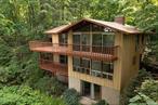 Iconic Mid-Century Modern tri-level Techbuilt home, constructed in redwood and glass, and privately tucked away on a sloping wooded acre with direct access to the Old Erie Rail trail and just 15 miles from NYC. Vaulted ceilings and exposed beams, create open sunny spaces with glass walls, multiple decks and oversized sliders that bring the outdoors right in. Bask deeply in nature among the canopies of mature trees, and take in the seasonal Hudson River views. Intentionally designed upside down, with the bedrooms below the main living areas, to best capture views and maximize privacy. Enter on the main level with a circular floor plan of kitchen, dining room, and living room, anchored by a brick wood-burning fireplace to cozy up to during the winter months. A half bath plus a versatile office or guest room, are also on this main level. The stairway down to the second level leads you to 3 bedrooms, & 2 full baths, including a primary suite with it&rsquo;s own private deck, walk-in closet, and en suite bath. Everyone wakes up to wooded views from all the bedrooms. Walk past a back laundry area and down to a finished ample walkout lower level for added practical extra space for recreation or storage. 2- car carport to protect from the elements. Youâ€™ll enjoy both privacy and easy access to Nyack and Piermont Villages. A great opportunity to own a vintage modern architectural gem just minutes from NYC, where classic design meets modern convenience in a truly serene setting.