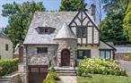 Stunning 1930s Stone Tudor in the Highly Sought-After Aubyn Manor/Hunts Woods Park area. Crafted by the renowned local builder Peter Rhynas, known for his spacious designs, exceptional millwork, and custom finishes, this bright and inviting Stone Tudor is a true masterpiece. Topped with a timeless slate roof, it beautifully blends historic charm with modern updates. Nestled on a picturesque, tree-lined street in the coveted Aubyn Manor enclave, this home offers unparalleled convenience just minutes from Bronxville Villageâ€”where youâ€™ll find an array of restaurants, shops, a movie theater, New York Presbyterian Hospital, and Fleetwood Metro North station. Itâ€™s the perfect combination of suburban tranquility and easy city access.As you step inside, youâ€™ll immediately appreciate the gleaming hardwood floors that flow seamlessly throughout the home. The updated kitchen is designed with todayâ€™s lifestyle in mind, providing a perfect space for culinary creativity. The reimagined dining room offers a sophisticated setting for effortless entertaining. The sunken living room is a true showstopper, featuring a wood-burning fireplace, soaring ceilings, and French doors that open to a private, landscaped backyard oasis. Enjoy your own enclosed garden and slate patioâ€”an ideal retreat for relaxation or gatherings.Upstairs, the serene primary suite serves as your personal sanctuary, complete with a custom walk-in closet and a luxurious bath with double vanity and soaking tub. Two additional spacious bedrooms each boast generous 6-foot-wide closets and share a beautifully appointed full bath. The third floor features a versatile private bedroom suite, perfect for guests, a home office, gym, or even a fourth bedroom.Move right in and experience a home where classic elegance and modern comfort come together in perfect harmony.