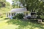 Check out this charming colonial-style farmhouse with great curb appeal. This property also features a beautiful yard with a detached one-car garage as well as a small outbuilding. The home has two covered porches for great outdoor relaxing in all seasons. This home creates a sense of nostalgia once you step inside. The main level has a mud room/laundry room. galley kitchen, separate dining room and spacious living room with a fireplace. The primary bedroom is on this level with it&rsquo;s own fireplace and there is a second bedroom used as an office, plus a full bath. Upstairs leads to a large loft with several sleeping areas. Don&rsquo;t miss out on this special property located in Long Eddy and not far from access to the Delaware River.