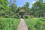 Nestled on a coveted, peaceful country road situated between two amazing natural features, sits your new investment or vacation home. This beautifully restored 1920s chapel is a rare find. Once part of the historic Rip Van Winkle Youth Camp, the home retains its original character, while offering every modern comfort. Hang out in the screened in porch sipping your morning coffee, relax in the hot tub on the brand-new wood deck as you listen to the rushing sounds of Kaaterskill Creek and waterfalls, or enjoy spring evenings filled with the sound of peepers. If you&rsquo;re a nature lover, you can watch bald eagles, foxes, great blue herons, and other wildlife from your own backyard. A pollinator garden envelopes the porch, attracting hummingbirds and butterflies all summer long. Thoughtfully updated, the chapel features a new standing seam metal roof with snow guards, new gutters, a cozy and efficient wood stove, and new mini-split system for efficient heating and cooling. Additional upgrades include a full-house water filtration system, 200-amp electric service, an outdoor shower for hot summer days, and a brand-new hot tub for chilly winter nights. Currently an active and highly rated Airbnb â€” bookings and short term rental permit can transfer to the new owner. Escape to the country while staying close to it all! This property is less than 30 minutes from premier skiing, thrilling zip-lining, and countless outdoor adventures. Surrounded by scenic hiking trails and nature preserves, it&rsquo;s also just a short drive to charming towns like Catskill, Hudson, and Woodstockâ€”each offering unique shops, restaurants, and cultural attractions. Conveniently close to major amenities and year-round activities, this location offers the perfect balance of tranquility and accessibility. If you&rsquo;re looking for a unique turnkey retreat with unmatched character and history, this enchanting cabin is a must-see. Properties with this much charm don&rsquo;t stay on the market for long.