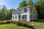 Discover the endless potential in this historic colonial home. Officially listed as 3 bedrooms, this home lives like a 5-bedroom with 1.5 baths and all the character of the 1800s, including original wide plank floors. Nestled on 2.11 acres of private land, the backyard feels like a dream retreatâ€”lush, expansive, and perfect for exploring. The detached two-story barn offers limitless possibilities, whether you want a workshop, man cave, or creative studio. While the property needs TLC, including a new driveway and cosmetic updates, itâ€™s a true opportunity to bring a piece of history back to life. Donâ€™t just buy a homeâ€”own a story, own your legacy.