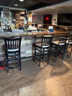 Turn Key business opportunity. Local busy bar and grill restaurant with loyal clientele. This first floor bar and outdoor seating area hosts music events and gatherings throughout the year. Business owner recently updated the interior and exterior patio. Unit includes: 3 Public Restrooms , Storage, Grill, Kitchen and all appliances and Surveillance system are included in sale.
