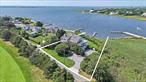 Welcome to elegant waterfront living at 69 Shore Road, Westhampton, NY. This exquisite 3, 400+/- square foot residence offers a harmonious blend of modern luxury and serene natural beauty. With five bedrooms and three and a half bathrooms, this turn-key home boasts upgraded smart technology features including internet outdoor lighting, remote shades, & outdoor Sonos speakers, ensuring a seamless living experience. Inside you&rsquo;ll discover expansive water and sunset views that captivate from every angle. The main level provides a formal living area, enhanced by an inviting fireplace, a large screened in porch, separate den/media room with pocket doors for privacy, and a spacious gourmet kitchen equipped with Wolf, Viking, & Bosch stainless steel appliances. Upstairs, the primary suite, with its private waterside balcony, & en-suite bath. Down the hall sits four guest bedrooms with two hall baths and a bonus sitting/media area. Outdoors, enjoy the secluded backyard, perfect for entertaining or relaxation. An outdoor kitchen with grill, warmer, fridge, hot & cold sink, along with multiple decks, a refreshing pool, and a 180-foot floating boat dock & dock box. The property overlooks the picturesque Westhampton Golf Course, adding to its allure. This home is designed for comfort and style. Discover unparalleled waterfront living today.
