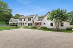 On a quiet cul-de-sac just moments away from East Hampton Village and ocean beach, this interior designer&rsquo;s own residence has been thoughtfully reimagined with updates that blend modern sophistication and timeless comfort. Every detail reflects a curated eye for design, elevating both style and livability. The home is organized into three distinct sections-perfect for both entertaining and retreat. The central entry opens to light-filled living spaces featuring wide plank pickled pine flooring and airy proportions. A family room with wood-burning fireplace flows seamlessly into the chef&rsquo;s kitchen, outfitted with marble countertops, waterfall island, Wolf and Sub-Zero appliances, and sleek custom cabinetry. The dining room and additional living room with fireplace extend the open feel, with all three spaces connecting to the patio and pool through glass doors. The primary wing offers a serene primary suite with vaulted ceilings, skylight, walk-through closet, and spa bath with soaking tub, frameless glass shower, and double vanity. A sauna completes the suite. Upstairs, a private guest suite provides comfort and seclusion. The second floor is complete with three additional bedrooms, among them an en-suite featuring designer barn doors and a custom bath. Off the kitchen, there is a full bath, mudroom, laundry, and access to the 2-car garage. Above the garage, a spacious studio currently serves as a recreation lounge with custom banquettes. Outdoors, the property is framed by beautifully landscaped grounds with mature trees, ornamental plantings, and seasonal gardens that create a sense of seclusion. A scenic easement along two sides of the lot further enhances privacy, ensuring uninterrupted enjoyment of the bluestone patio, outdoor living and dining areas with fireplace, heated gunite pool and spa, pool house with kitchenette and automatic door, plus an outdoor shower and changing area. This home embodies the best of Hamptons living-a designer&rsquo;s vision realized in a tranquil yet convenient location.