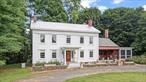 Originally built in 1836, this beautifully renovated Federal-style farmhouse is rich with history and character, once part of the Underground Railroad and also used as a Quaker meeting hall. Set on over four acres with Willow Brook meandering through, this one-of-a-kind property offers a peaceful, storied setting with modern comfort woven throughout. Inside, original wide board floors, exposed hardwood beams, and intricate molding and trim work highlight the home&rsquo;s craftsmanship. The center hall layout leads to a stunning double parlor with two fireplaces and original pocket doors, as well as an open dining and living room boasting two additional fireplaces, perfect for gatherings both intimate and large.The heart of the homeâ€”a warm and inviting kitchenâ€”features a wood-burning fireplace, gas stove, island, walk-in pantry, and laundry room. From here, step out to a screened porch â€”ideal for morning coffee, evening relaxation, or weekend entertaining. Upstairs you&rsquo;ll find 3 spacious bedrooms and 3 full bathrooms, as well as a room that could be used as a 4th bedroom, a custom walk-in closet/dressing room, or sitting room. The attic is a versatile space and can be reached by 2 separate staircases. The exterior boasts classic clapboard siding, metal roof, original 6-over-6 windows, raised garden beds, a fenced backyard, and several vintage outbuildings. In the basement you&rsquo;ll find updated mechanicals and the original milkroom with bluestone floor, echoing the home&rsquo;s agricultural past. Located just 3 miles from the Taconic State Parkway, this exceptional property is a beautiful blend of historic significance and modern functionalityâ€”a truly one-of-a-kind opportunity not to be missed.