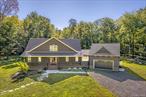 Tucked away in a peaceful country setting yet just minutes from some of the Hudson Valley&rsquo;s most beloved destinations, this thoughtfully designed home offers the perfect balance of luxury, comfort, and sustainability. A light-filled open floor plan showcases soaring ceilings and a beautiful stone fireplace that anchors the living space. Walls of windows bring the outdoors in, seamlessly connecting the interior with its natural surroundings. An elegant chef&rsquo;s kitchen featuring custom cabinetry, high-end appliances, a generous center island, and a wine barâ€”is ideal for both everyday living and entertaining. First-floor primary bedroom, complete with an en-suite bath, walk-in closet, and private porch access. Upstairs, two additional bedrooms, a full bath, and family room provide inviting accommodations for guests or quiet relaxation. Practical details, such as a breezeway-connected two-car garage and mudroom, adds both convenience and charm. A full basement offers a wine cellar and walk-out access, while a whole-house generator provides peace of mind year-round. A state-of-the-art geothermal system enhances the home&rsquo;s energy efficiency, underscoring its modern sustainability. The property is securely gated and enclosed by surround fencing, creating a private haven of peace and tranquility. Designed for both leisure and adventure, the landscape invites you to gather around the firepit and enjoy the ridge views or explore the wooded trails. Expansive patios and decks create the perfect backdrop for al fresco dining and entertaining. Completed just last year and enhanced with premium upgrades, this residence is truly turnkey and one of a kind. With proximity to Minnewaska State Park, Mohonk Preserve, Tillson Lake, Wildflower Farms and countless farm-to-table experiences, the best of Hudson Valley living is at your doorstep.