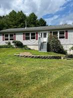 This lovely country home could be your escape from the city or a great starter home. Features include an open living/dining area, woodstove, large party deck, three bedrooms, hardwood floors, and two baths. Appliances are new. Full basement with one car garage and storage shed. Property is 1.33 acres of lawn and mature forest, with most of the lawn fenced for children or pets. Located close to the Delaware River, the Homestead School and trains to NYC.