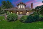 Welcome to this Cape Cod-style home in the heart of Wappingers Falls, NY. Built in 1920 and thoughtfully cared for over the years, this residence rests on a 1.53-acre lot with mature trees that anchor the property with timeless beauty. Offering 4 bedrooms and 2 baths across 2, 775 square feet, it blends warmth, character, and everyday comfort.The inviting covered porch sets the tone before you even step inside. Once through the door, the living room becomes the centerpiece of the home, with its wood-paneled walls and cozy fireplace that feels both welcoming and enduring. The homeâ€™s layout flows into flexible spaces, including a bonus room with built-in shelving, perfect for a home office, study, or creative pursuits.The kitchen combines practicality and tradition, with abundant cabinetry, space for a large dining table, and direct access to the backyard for easy indoor-outdoor living. Upstairs, generously sized bedrooms and custom built-ins highlight the craftsmanship of the era, offering one-of-a-kind storage solutions you wonâ€™t find in newer homes.A clean and dry basement further extends the storage opportunities. Outdoors, the property continues to impress with a detached garage, a barn-style outbuilding suited for storage or workshop needs, and a private backyard designed for relaxation or gatherings.Set in Wappingers Falls, this home combines space and character with a location that keeps everyday life within easy reach. Enjoy nearby access to Metro-North trains, Route 9 shopping and dining, and the scenic Hudson River. Whether you want room to spread out at home or quick connections to local amenities, this property brings both together in one inviting setting.