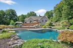 Welcome home to this exceptional 3-bedroom, 2-bath sprawling ranch set on 4 private acres in a truly idyllic setting. This beautifully maintained residence offers effortless single level living with hardwood floors throughout and an open, inviting layout.Step outside and experience your own private paradise. The professionally landscaped grounds are thoughtfully designed with Hudson Valley-native shrubs, mature trees, natural rock features, and lush grass that enhance the natural beauty of the property. A Trex deck overlooks the show-stopping backyard, featuring a breathtaking heated, free-form gunite saltwater pool with LED lighting and multiple cascading waterfalls. Just steps away, relax in the standalone jacuzzi tub and enjoy serene views of your peaceful acreage.Inside, the spacious living areas are perfect for entertaining or quiet evenings at home, and the full basement offers endless possibilities. A brand-new driveway completes this move-in ready home and adds to its outstanding curb appeal.This stunning ranch delivers the perfect combination of luxury, privacy, and natural beautyâ€”perfect for enjoying the best of Hudson Valley living.