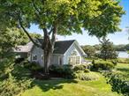 Your North Fork Waterfront Haven Awaits- A Rare waterfront 1947 Nantucket cedar shingled expanded home. Escape to your dream retreat. Imagine waking up to 300 feet of serene and pristine inlet waterfront, just moments from Peconic Bay, in your very own nantucket cottage that has been lovingly preserved for nearly a century. Only 90-minutes from NYC or Brooklyn - This 11 room, 4- bedroom, 3-bath retreat exudes timeless charm. Built nearly a century ago, this cherished home retains its original character and sits on 1.1 acres along a beautiful waterfront, and your private oasis of open lawn, specimen trees and beautiful gardens stretching 300 feet along the water with acres of borrowed landscape as far as your eyes can see of salt marsh estuaries and water out to The Peconic bay. The parklike grounds are complete with a long private dock in excellent condition for boats up to 35ft (1.5ft min. low tide)Inside vaulted ceilings in the large eat in kitchen with panoramic water views flow to waterside expansive decks, perfect for sunset dinners and entertaining. The screened porch off the deck is a perfect addition. The living room with fireplace offers sweeping inlet views, while the cozy library/den invites quiet reflection. Imagine waking up in any of the waterside bedrooms with wonderful views. The first floor primary suite which offers gorgeous water views and full bath. Upstairs are 3 additional bedrooms with 2 full baths, and a large accessible attic that could easily be finished off for an additional bedroom. An expansive full basement and an attached very large 2 car garage. Located in Cutchogue, surrounded by the North Forks bucolic beauty, think acres of vineyards, a vibrant food scene, Zagat rated Restaurants, golf, marinas- boating is excellent, Beaches, hiking and nature preserves offered in every hamlet. Close to Trains and the Jitney. This is a rare opportunity to own a piece of paradise and create your own memories in this rare waterfront offering. Call today for a private showing.
