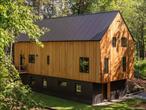 A stunning and private contemporary new build on 3 acres just minutes to Rhinebeck and Red Hook village. The main floor living space is light filled with 28ft soaring ceilings and the home has radiant concrete floors. The open kitchen is streamlined with a 36â€ five-burner gas cooktop, a large center island clad in white oak and gorgeous black granite countertops. The two spacious bedrooms on the main floor feature big picture windows with views looking out over the property, and youâ€™ll find large closets in each. The primary is ensuite with a double vanity & a large tiled shower. The walkout lower level has a large mudroom with gorgeous custom-built white oak floor-to-ceiling cabinetry, the home has loads of storage. You&rsquo;ll also find a living/media room, a third bedroom and a stunning full bath with a soaking tub. The top floor of the home is a fun and flexible open space with a vaulted ceiling that looks down over the main living area. Perfect as a playroom, extra sleeping quarters, an office, studio, etcâ€” possibilities abound. Outside, a large deck overlooks the lawn, and you&rsquo;ll find an outdoor shower. The exterior is clad in beautiful tongue and groove cedar with a unique cantilever design, and the home boasts high efficiency mechanicals, AC and a new metal roof. This new build is in Red Hook School District and sits in the heart of the Hudson Valley on a lovely, quiet and peaceful road, perfect for weekend or full time use. Just 2h north of NYC but a world away.