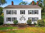 Charming 1840 Country Estate on 2.88 Acres â€“ Step into a beautiful farmhouse where timeless character meets modern comfort. Historic details include wide plank floors, exposed beam ceilings, brick accent walls, vintage doors, and multiple fireplaces. The property is equally enchanting outdoors, offering a circular driveway, carriage house (previous horse barn), the original Sugar House with loft, a classic outhouse, chicken coop, vegetable garden, apple and pear trees, a detached 2-car garage, in-ground pool with bluestone patio surround, basketball court, plus more. Upon entering this special home, youâ€™re welcomed by wide plank floors and timeless farmhouse charm. To the right, a cozy parlor features a wood-burning fireplace with original moldings and built-in shelves, while to the left, a sun-filled formal living room leads to the expansive kitchen with vaulted ceilings, exposed wood beams, granite counters and stainless steel appliances. The kitchen opens to a dining area accented by a brick wall and propane fireplace, perfect for gatherings. A nearby sitting room with sliding glass doors provides access to a private patio and the tranquil sound of the waterfall in the small frog and goldfish pondâ€”an ideal setting for relaxation and outdoor enjoyment. Upstairs features three generously sized bedrooms and a versatile den/officeâ€”ideal as a nursery or home workspace and a full bathroom. Walk-up unfinished attic with stunning black walnut floors offers endless possibilities for additional living space. This property perfectly blends historic charm with modern potential, inviting you to transform it into your dream home. A rare find!