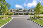 Brookville  An immaculate modern colonial has made its debut in Brookville. Sitting on 2.57 acres and totaling over 8, 600 sq.ft. of living space, welcome to 8 Dogwood Hill - a newly completed luxury residence located on a lengthy, picturesque street just off of Cedar Swamp Road. Beyond the stone pillar entrance at the end of the driveway are two courtyards with belgium block accents that lead to the home - featuring a sleek white exterior, complemented with stone accents and black windows.Entering through the front door welcomes you into the lofty foyer, revealing an elegant staircase leading to the second floor, large coat closet and marble powder room, catering to guests. Hidden behind a translucent glass door off the formal living room is a truly breathtaking space - a den with airy, cathedral ceilings, creamy oak paneling, and centered around a marble-encased fireplace. Paired with a powder room, this den can be transformed into a cozy retreat or private office space. Adding to the open-concept flow of the first floor, the formal living room leads to a spacious family room with a second marble fireplace, breakfast nook and the heart of the home - a custom chefâ€™s kitchen. Complete with a waterfall marble island, white oak cabinetry, paneled dual dishwashers and Sub-Zero refrigerator & freezer, envision everyday meals, holiday gatherings, and hosted parties in this aesthetic and inviting atmosphere. Off the kitchen is a galley-style butlerâ€™s pantry providing extra storage and a wet bar, leading to the formal dining room. Thoughtfully curated for the modern lifestyle is an optimized service area, conveniently connecting the main living quarters to the rest of the home and property. The mudroom connects a back, side, and garage entrance to built-in storage, a hidden pantry, and access to all three floors via the backstaircase or elevator. Additionally, the first floor full bathroom is accessible via an outdoor entrance off the pool, and the first floor bedroom provides an excellent guest space or maidâ€™s quarters. Making way upstairs and hidden behind double doors is a grand primary suite - offering an open bedroom and sitting area, separated by a double-sided marble fireplace. Just past the huge walk-in closet with build-in storage and island is a spa-like bathroom, with floor to ceiling marble tiling. Featuring a soaking tub with views of the front courtyard, double vanities and makeup station, the main highlight of possibly the entire home is a stunning, oversized walk-in shower. A rainfall showerhead is centered around steamers, body jets, and handhelds, with two benches, creating a tranquil escape to wash the day away. The second floor contains the remaining four bedrooms all feature en-suite full bathrooms and walk-in closets, full laundry room, and opportune bonus room with the potential to be transformed into a home office or play room. Outside, a 40â€™ x 20â€™ saltwater and heated gunite pool is surrounded by an expansive patio with outdoor kitchen, transforming the backyard into a private oasis. It also offers the opportunity to add personal amenities, such as a tennis/sports court or pool house, catering to your every need. The property features additional perks such as a full-home generator, central vac, radiant heat under all tile, smart home system, 3-car heated garage and an expansive lower level with outside access and potential to transform into a home gym/wellness center, media room, wine cellar or additional storage. Blending the Hamptonsâ€™ aesthetic and resort lifestyle with the prestige of Long Islandâ€™s North Shoreâ€”all while offering effortless access to New York Cityâ€”8 Dogwood Hill embodies the very best of modern luxury living.