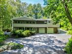 Welcome to this exceptional Expanded Ranch featuring 4-5 bedrooms and 4 bathrooms, nestled on 1.95 acres of serene beauty in Oyster Bay Cove&rsquo;s (Cove Neck section). A long private driveway can accommodate multiple vehicles, leading you to this remarkable residence, which includes a two-car attached garage with ample storage.Step inside to discover a stunning open floor plan accentuated by vaulted ceilings and walls of windows that showcase breathtaking views. The living room boasts hardwood floors and a cozy wood-burning fireplace, while the dining room also features hardwood flooring. The family room is adorned with beautiful natural stone floors and another fireplace, with additonal vaulted ceilings creating a warm and inviting atmosphere.The spacious, updated eat-in kitchen is equipped with granite countertops, making it ideal for entertaining. You&rsquo;ll find multiple living areas throughout the home, including a expansive second great room complete with vaulted ceilings, walls of windows, a full bath, and a separate outside entrance.For added convenience, there&rsquo;s a separate in-law suite or home office featuring its own entrance, full bath, and a summer kitchen/wet bar. The tranquil, secluded backyard is an entertainerâ€™s dream, featuring a gunite inground pool and plenty of seating areas on a beautiful paver patio for family gatherings and social events.As a bonus, the community offers a private beach with parking, perfect for kayaking, swimming, sunbathing, or simply enjoying the stunning sunrises and breathtaking views of cold spring harbor. This home also comes with deeded mooring boat rights. Located close to restaurants, shopping, town beaches, and the LIRR, this property is truly a perfect place to call home!